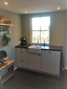 a kitchen with a sink and a window at House of Flowers 