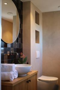 a bathroom with a sink and a mirror at House of Flowers 