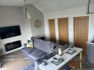 a living room with a couch and a table at Beach View Apartment with balcony and sea view - pet friendly in Cleveleys