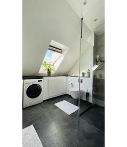 a bathroom with a sink and a washing machine at ApartmentInCopenhagen Apartment 158 in Copenhagen