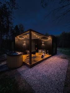 a gazebo with a cat sitting in it at night at w lesie in Skrwilno