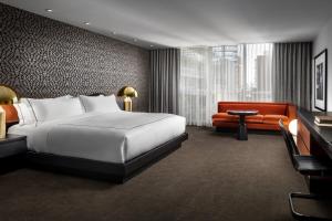 a hotel room with a bed and a couch at Bisha Hotel Toronto in Toronto