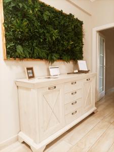 a green wall in a room with a dresser at Luxury Beach House in Torvaianica