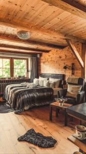 a bedroom with a large bed and a couch at Chalet Harmonie in Inzell