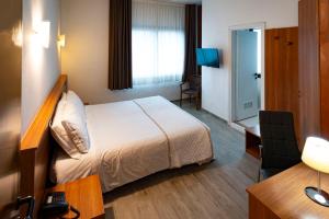 a hotel room with a bed and a desk at Hotel Nuova Mestre in Mestre