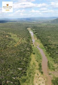 an aerial view of a river in the savannah at Amakhosi Safari Lodge & Spa in Magudu