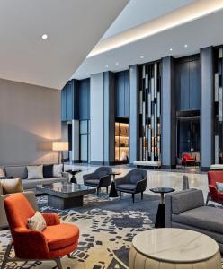 a lobby with couches and chairs and tables at Loews Kansas City in Kansas City