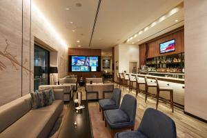 a bar in a hotel with couches and chairs at The Lofton Hotel Minneapolis, Tapestry Collection by Hilton in Minneapolis