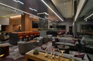 a hotel lobby with couches and a bar at Loews Hollywood Hotel in Los Angeles +105 photos