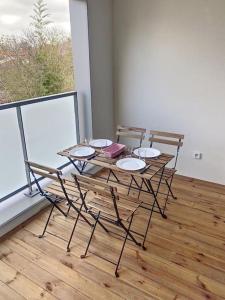 stół i krzesła w pokoju z oknem w obiekcie CAPRI - Sublime T2 Patte d'oie (Netflix, Terrasse) w Tuluzie