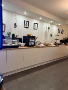 a kitchen with white cabinets and a counter at Hôtel La Villa Cannes in Cannes