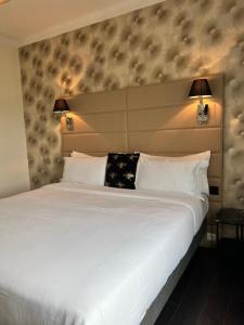 a bedroom with a large white bed with two pillows at Hôtel La Villa Cannes in Cannes