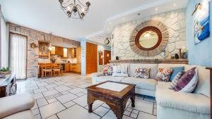 a living room with a couch and a table at Willa Jazgór, Sun & Snow in Jastrzębia Góra