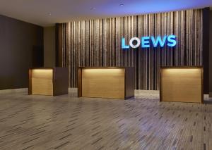 a row of elevators in a lobby with a neon sign at Loews Vanderbilt Hotel in Nashville