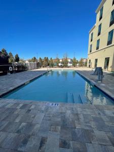 a swimming pool in front of a building at Pestana Orlando Suites - Lake Buena Vista in Orlando