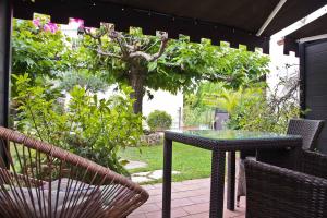 a table and chairs on a patio with a tree at Hôtel La Villa Cannes in Cannes
