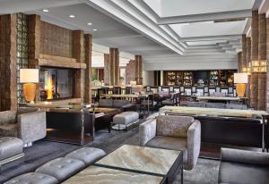 a lobby with couches and tables and a fireplace at Loews Ventana Canyon Resort in Tucson