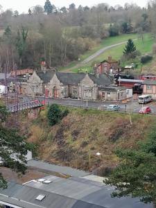 a town on a hill with a train on a road at Halt Cottage in Bridgnorth