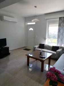 a living room with a couch and a coffee table at Katerina Villa In Kiotari in Kiotari