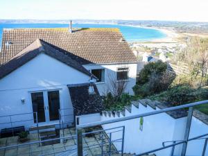 a white house with a view of the beach at Rosemount in Marazion