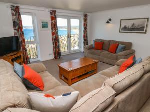 a living room with a couch and a tv at Rosemount in Marazion