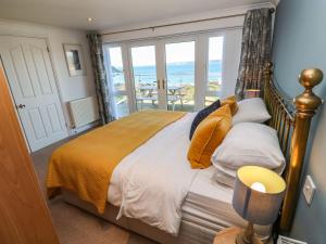 a bedroom with a bed with a view of the ocean at Rosemount in Marazion
