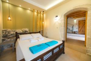 a bedroom with a bed with two towels on it at Villa Cretan View with Heated Swimming Pool in Pátima