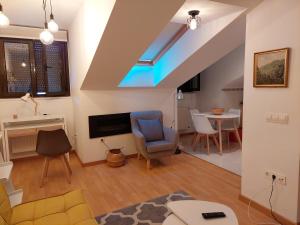 a living room with a skylight and a table and chairs at Los Ojos Del Cuera in Posada de Llanes