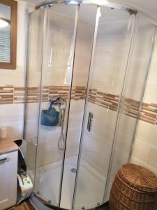 a shower in a bathroom with white walls at Apartmán Dvě Micky in Pec pod Sněžkou