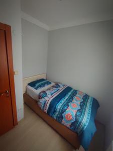a bedroom with a bed with a colorful blanket on it at Ağva'da Villa in Sile