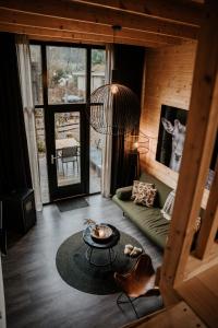 uma sala de estar com um sofá e uma mesa em Tiny house op de Veluwe em Beekbergen