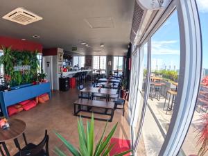 a restaurant with tables and chairs and a balcony at Comfort Hotel Santos in Santos