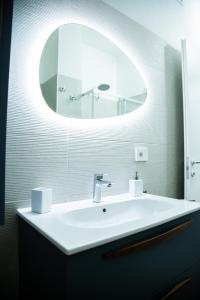 a bathroom with a white sink and a mirror at STUDIO 47 - CITY LIFE in Milan