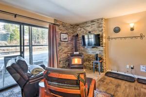 uma sala de estar com um sofá, uma cadeira e uma lareira em Lovely Kirkwood Condo - Walk to Ski Lift and Village em Kirkwood
