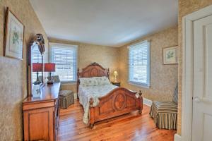 a bedroom with a bed and a desk and windows at Striking Cape May Getaway, Steps From the Beach! in Cape May