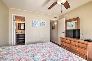 a bedroom with a bed and a flat screen tv at Sun-Dappled Condo with Balcony and Secluded Beach! in Myrtle Beach