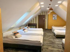 a group of three beds in a room at Hotel Fero Express POKOJE KLIMATYZOWANE AC in Krakow