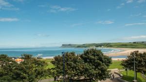 a view of a beach and the ocean at Marine Hotel Ballycastle in Ballycastle