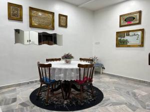 a dining room with a table with four chairs at One's Homestay in Seri Manjung