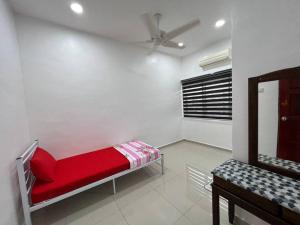 a room with a red bed and a mirror at One's Homestay in Seri Manjung