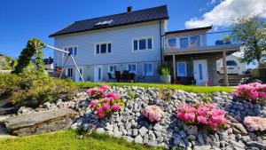 a house with a rock garden in front of it at Apartment Ulsteinvik in Ulsteinvik