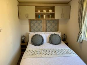 a bedroom with a bed with two pillows on it at Abi in St Austell