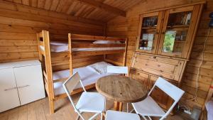 um quarto com uma cama, uma mesa e cadeiras em Ferienholzhaus Strandbude mit Terrasse em Ahlbeck