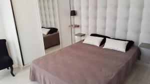 a bedroom with a large bed with two pillows on it at '' FLEUR DE SEL '' in Saint-Hilaire-de-Riez