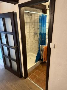 a bathroom with a shower and a shower curtain at Chata v srdci Krkonoš in Kořenov