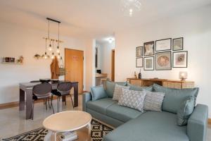a living room with a couch and a table at Comboio I by An Island Apart in Funchal