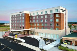 a large building with a parking lot in front of it at Courtyard by Marriott North Brunswick in North Brunswick