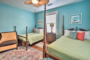 a bedroom with two beds and a ceiling fan at Downtown Daytona Beach Home Walk to Halifax River in Daytona Beach