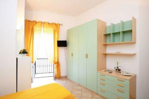 a bedroom with a bed and a dresser and a window at La Piazzetta in Amalfi