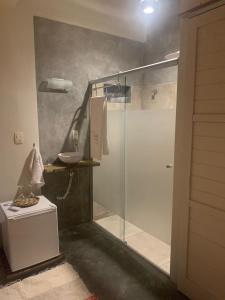 a bathroom with a glass shower and a sink at A casa di Maria in Ubatuba +65 photos